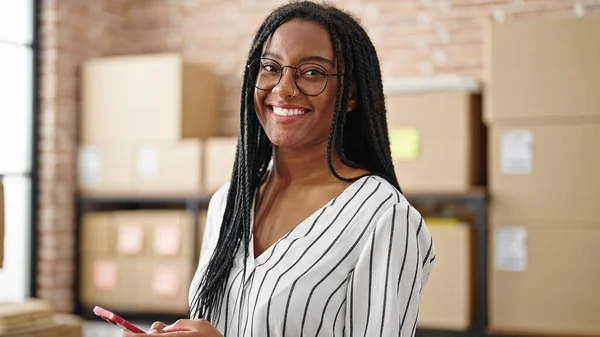 アフリカ系アメリカ人女性 オフィスで笑顔を見せるスマートフォンを使ったビジネスワーカー — ストック写真