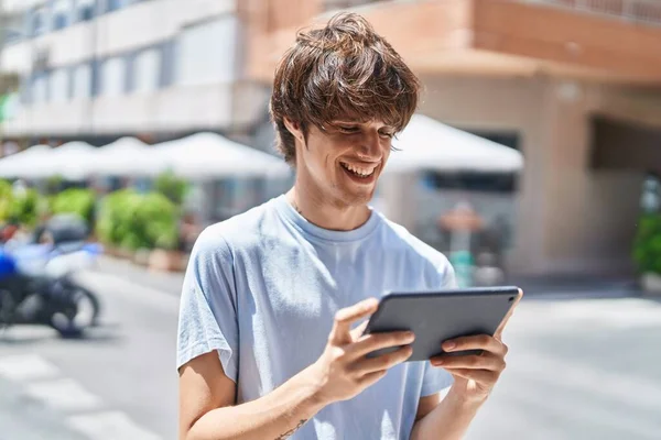 Young Blond Man Smiling Confident Watching Video Touchpad Street —  Fotos de Stock