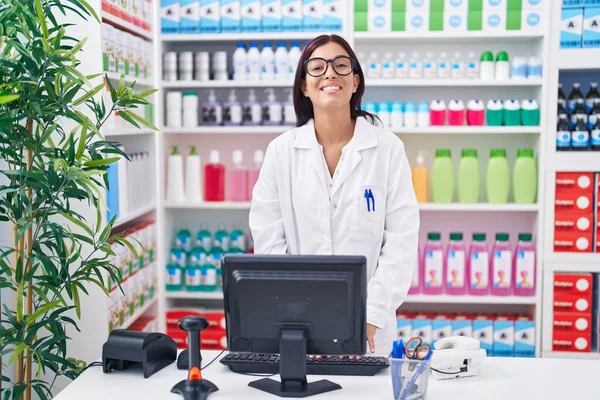 stock image Young beautiful hispanic woman pharmacist smiling confident using computer at pharmacy