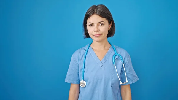 Young Beautiful Hispanic Woman Doctor Standing Serious Expression Isolated Blue — Stock Photo, Image