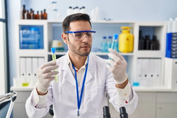 Young Hispanic Man Scientist Holding Test Tubes Laboratory — Fotografia de Stock