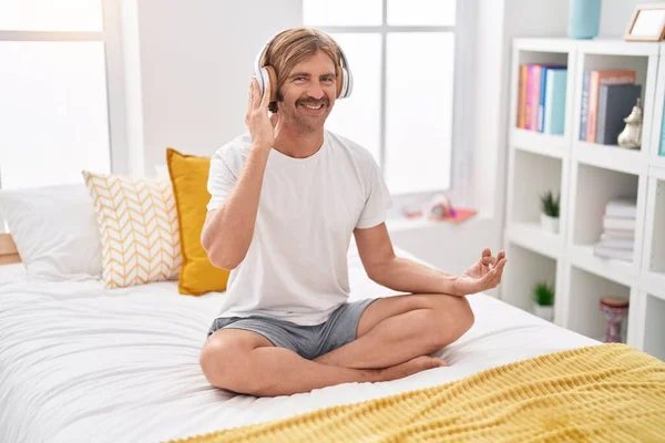 Young Blond Man Doing Yoga Exercise Sitting Bed Bedroom — Stok fotoğraf