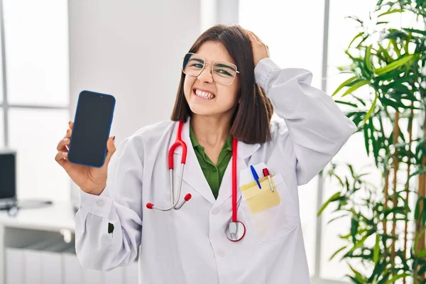Ung Latinamerikansk Läkare Kvinna Visar Smartphone Skärmen Stressad Och Frustrerad — Stockfoto