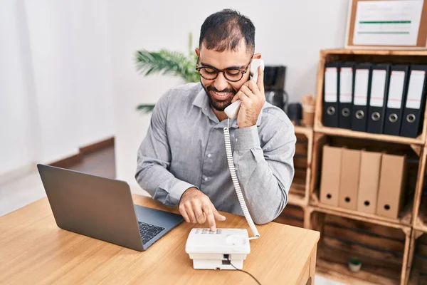 Young Hispanic Man Business Worker Talking Telephone Using Laptop Office — Stok fotoğraf