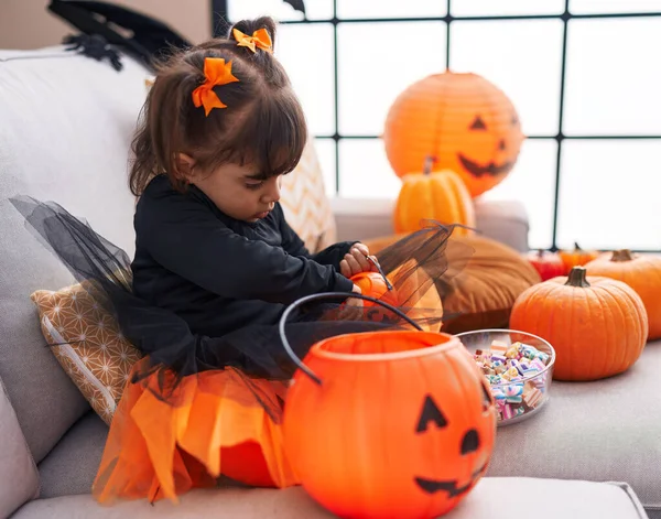 Adorable Hispanic Girl Wearing Halloween Costume Holding Pumpkin Basket Home — Foto Stock