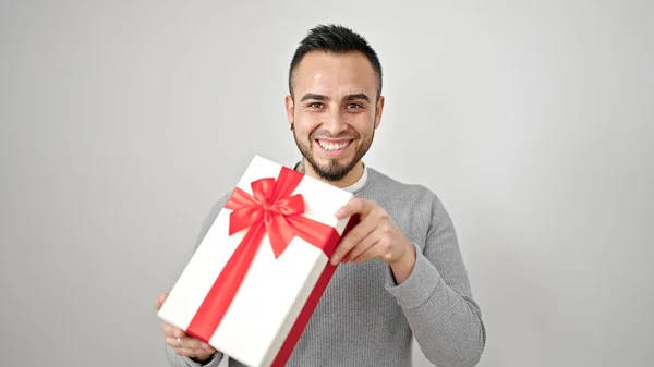 stock image Hispanic man smiling confident holding present over isolated white background