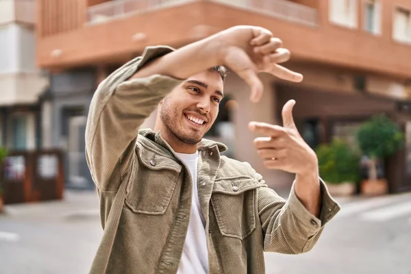 Young Hispanic Man Smiling Confident Doing Photo Gesture Hands Street — Fotografia de Stock