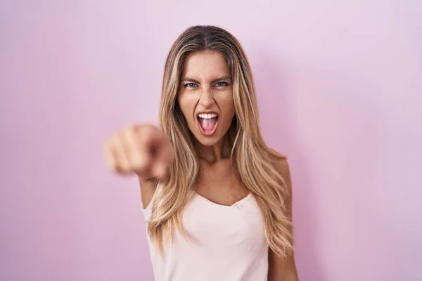 Young Blonde Woman Standing Pink Background Pointing Displeased Frustrated Camera — Stockfoto