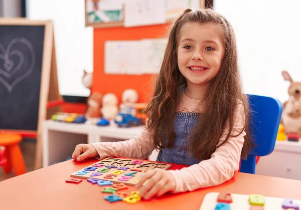Adorable Hispanic Girl Playing Maths Puzzle Game Sitting Table Kindergarten —  Fotos de Stock
