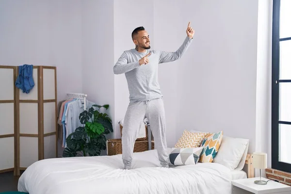 Young Hispanic Man Standing Bed Dancing Bedroom — Stockfoto