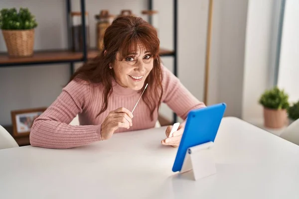 Middle Age Woman Doing Antigen Covid Test Sitting Table Home — Stockfoto