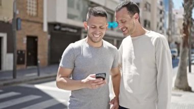 Two men couple smiling confident make selfie by smartphone at street