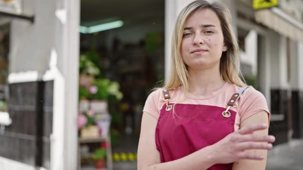 Joven Camarera Rubia Sonriendo Confiada Pie Con Los Brazos Cruzados — Vídeos de Stock