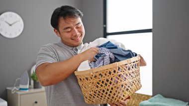  Çamaşır odasında kendine güveni olan sepet tutan