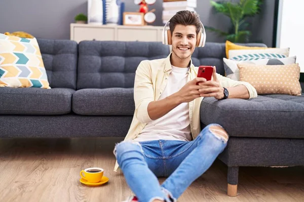 Young Hispanic Man Listening Music Sitting Floor Home — Foto Stock