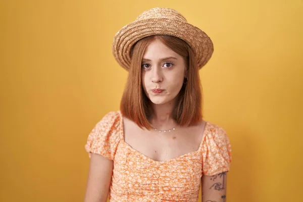 Young Redhead Woman Standing Yellow Background Wearing Summer Hat Puffing — Stock Photo, Image