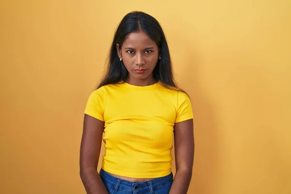 stock image Young indian woman standing over yellow background skeptic and nervous, frowning upset because of problem. negative person. 