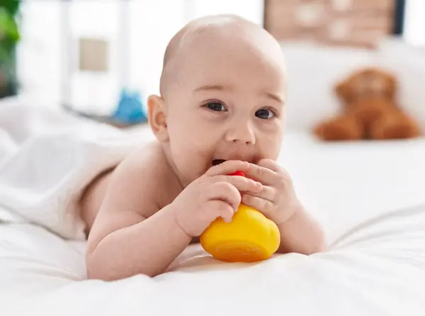 Liebenswert Kaukasisch Baby Liegend Auf Bett Lutschen Ente Spielzeug Schlafzimmer — Stockfoto