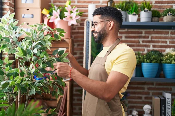 Young arab man florist using difusser working at florist