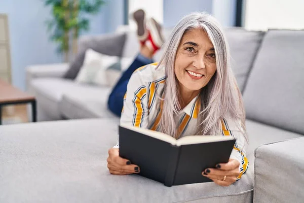 Middle Age Grey Haired Woman Reading Book Lying Sofa Home — Stock Photo, Image