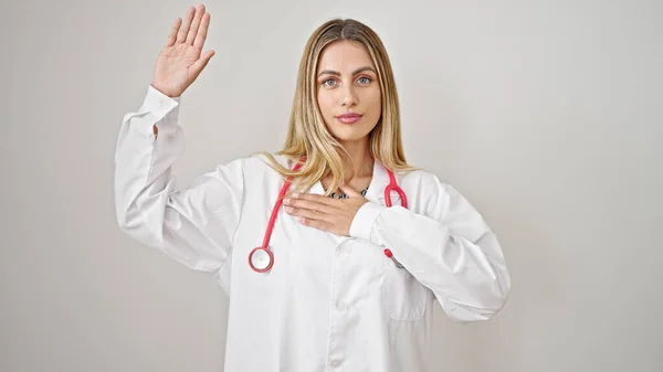 Young Blonde Woman Doctor Making Oath Hand Chest Isolated White — Stock Photo, Image