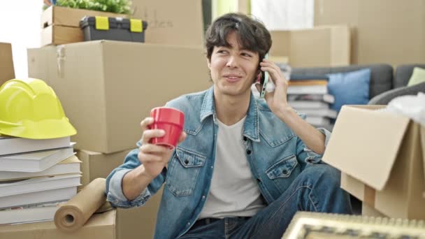 Young Hispanic Man Talking Smartphone Drinking Coffee New Home — Stok video