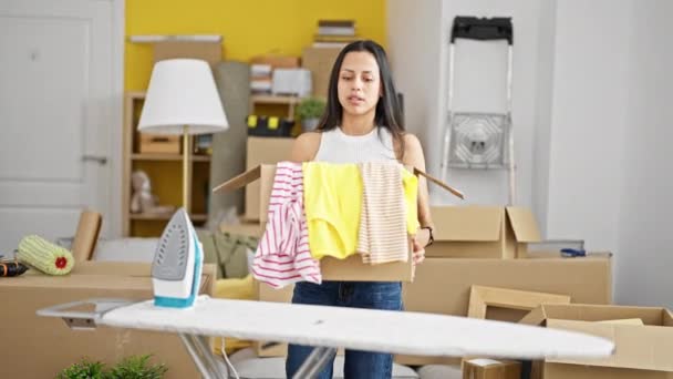 Young Beautiful Hispanic Woman Holding Package Clothes Tired New Home — Stock Video