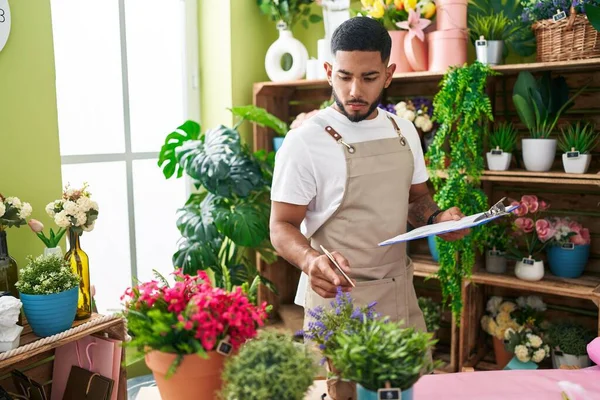 Young Latin Man Florist Holding Document Looking Flowers Flower Shop — Stock Photo, Image