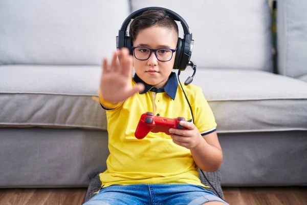 Young Hispanic Kid Playing Video Game Holding Controller Wearing Headphones — Stock Photo, Image