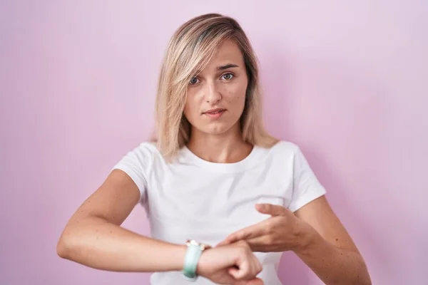 Young Blonde Woman Standing Pink Background Hurry Pointing Watch Time —  Fotos de Stock