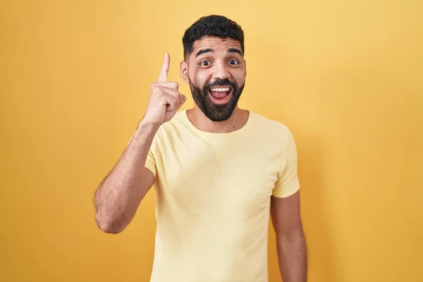 Hispanic Man Beard Standing Yellow Background Pointing Finger Successful Idea — Foto Stock