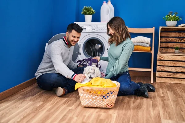 stock image Man and woman washing clothes with dog at laundry room