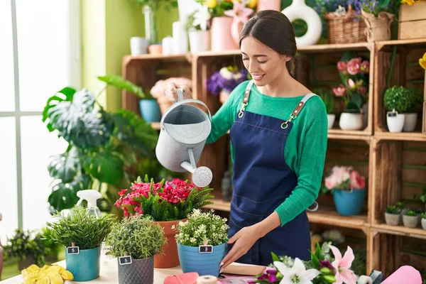 Young Beautiful Hispanic Woman Florist Smiling Confident Watering Plant Flower — Stock Photo, Image