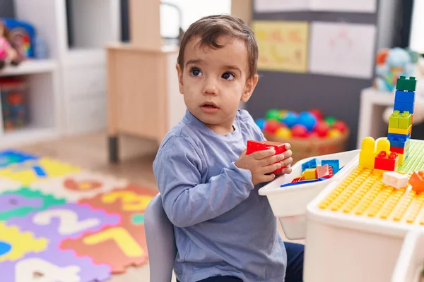 Adorable Hispanic Boy Playing Construction Blocks Sitting Table Kindergarten —  Fotos de Stock