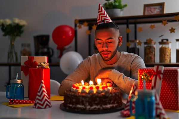 African American Man Blowing Out Candles Celebrating Birthday Home — Foto de Stock