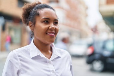 African american woman smiling confident looking to the side at street