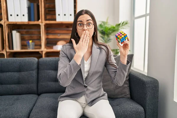 Hispanic Woman Playing Colorful Puzzle Cube Intelligence Game Covering Mouth — Photo