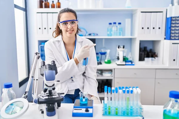 Young Hispanic Woman Working Scientist Laboratory Cheerful Smile Face Pointing — Stock Photo, Image