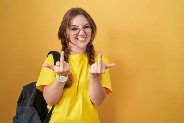 Young Caucasian Woman Wearing Student Backpack Yellow Background Showing Middle — Fotografia de Stock