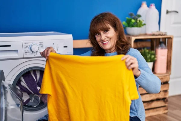 Middle Age Woman Holding Shirt Washing Clothes Laundry Room —  Fotos de Stock