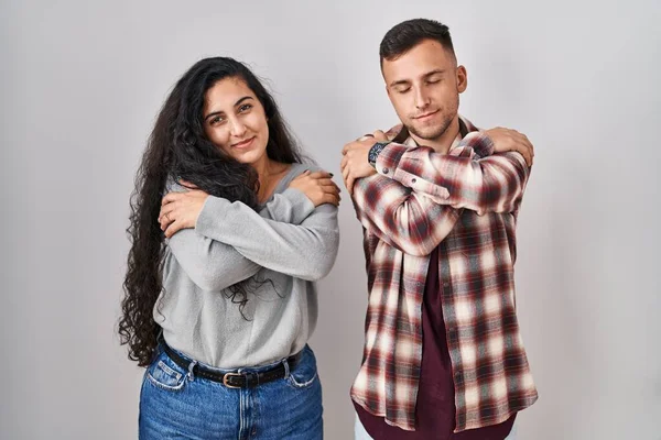 Young Hispanic Couple Standing White Background Hugging Oneself Happy Positive — Stock Photo, Image