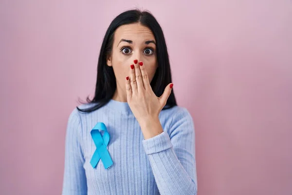Hispanic Woman Wearing Blue Ribbon Covering Mouth Hand Shocked Afraid — Stock Photo, Image
