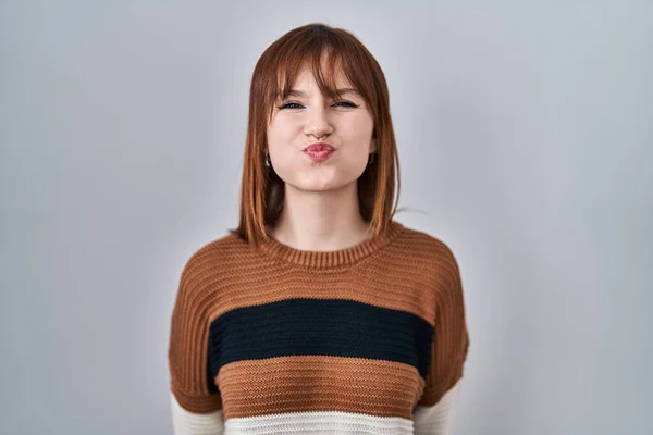 Young Beautiful Woman Wearing Striped Sweater Isolated Background Puffing Cheeks — Stock Photo, Image