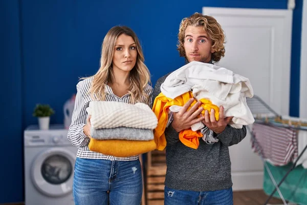 Young Couple Doing Laundry Skeptic Nervous Frowning Upset Because Problem — Fotografia de Stock