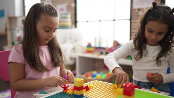Adorable Girls Playing Construction Blocks Sitting Table Kindergarten — Stock Video