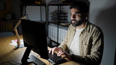 Young hispanic man business worker using computer working at office