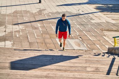 Young man running at street