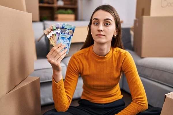 Young Caucasian Woman Sitting Floor New Home Holding Canadian Money — Stock Photo, Image