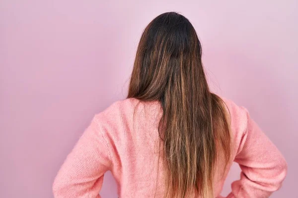 Young Hispanic Woman Standing Pink Background Standing Backwards Looking Away —  Fotos de Stock