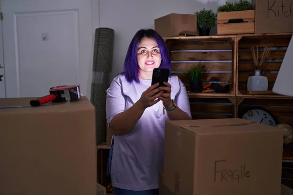 Young Beautiful Size Woman Smiling Confident Using Smartphone New Home — Stok fotoğraf